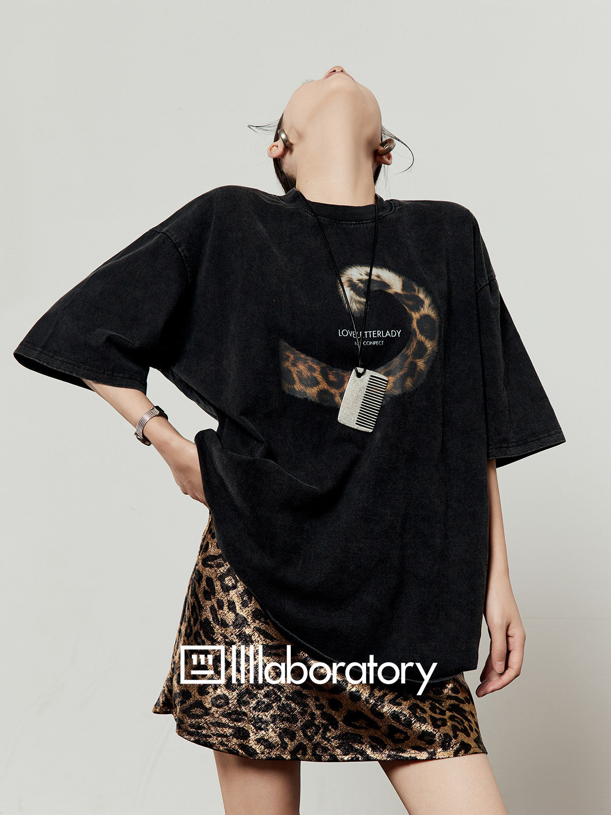 Washed black short-sleeve tee showing the original text and leopard-tail graphic