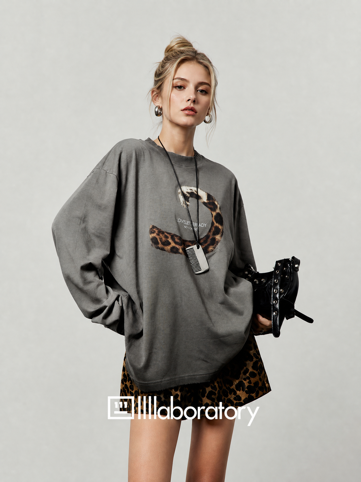 European blonde woman wearing the wasteland gray long-sleeve top and leopard-print skirt